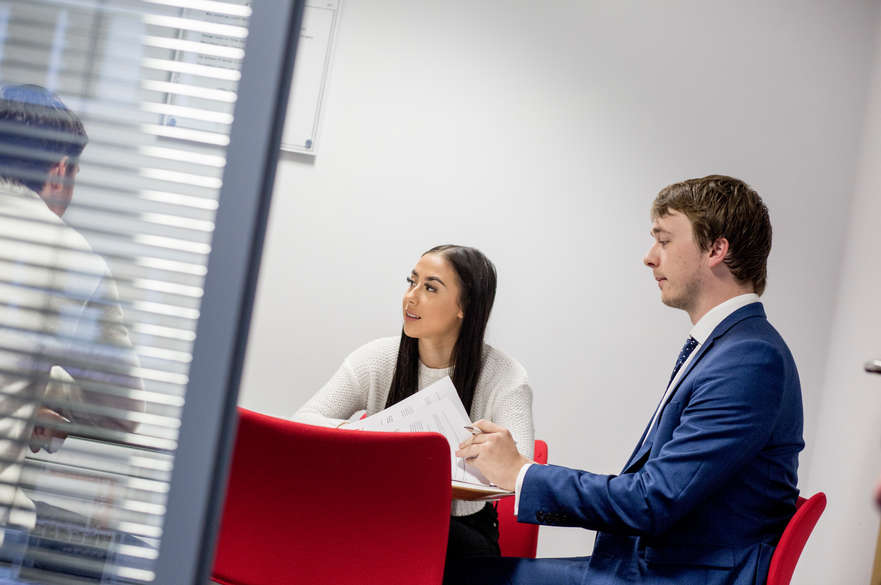 Student and solicitor consulting with a client