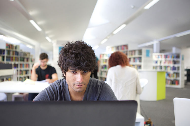 Student using laptop in library
