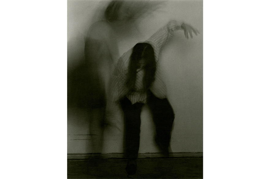A black and white blurred photo of a woman in two different animalistic poses