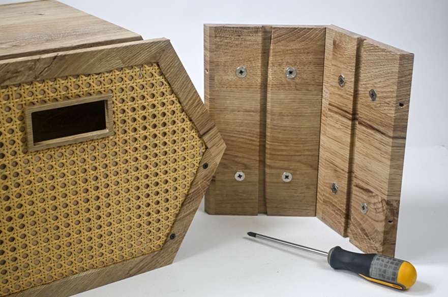 A wooden storage box and next to it a section of it to show how it is easy to assemple