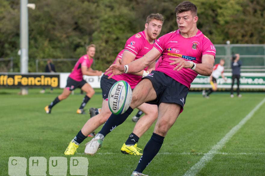 Alex Crocker kicks, with Jake Farnworth chasing