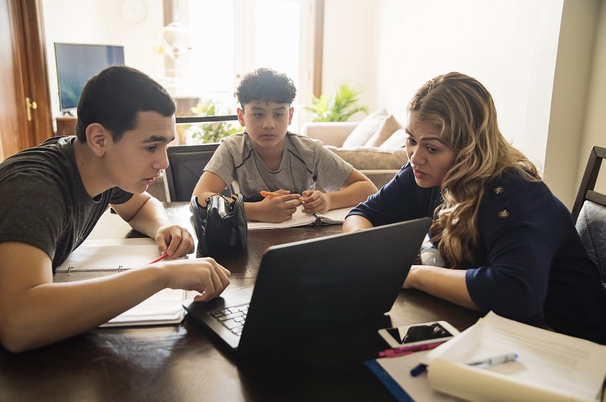 Group of three young people around a table