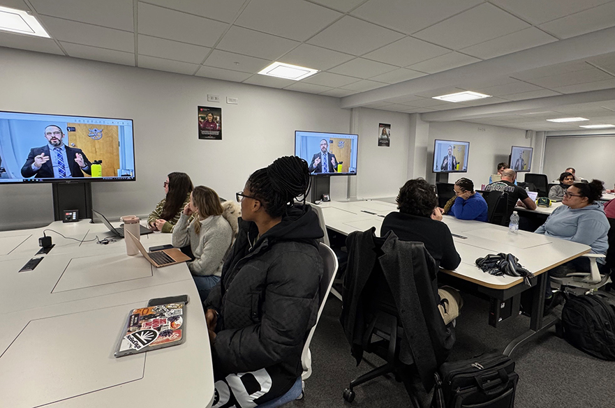 Cyberpsychology students receiving a virtual presentation from an FBI special agent