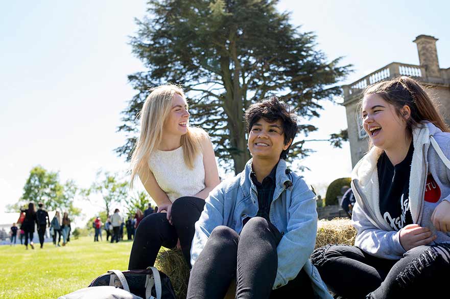 Students sat on hay bale