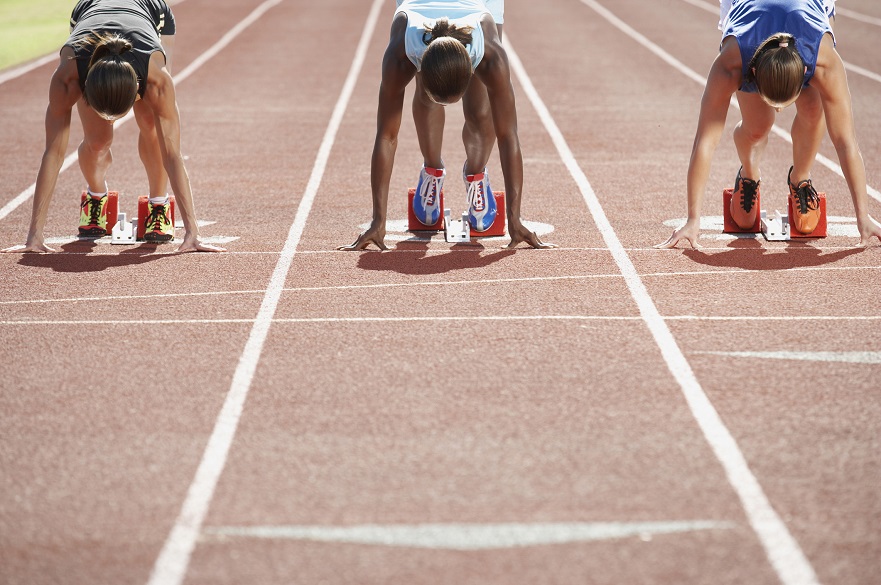 Female sprinters in the starting blocks