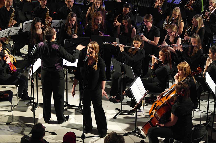 Girl singing with orchestra