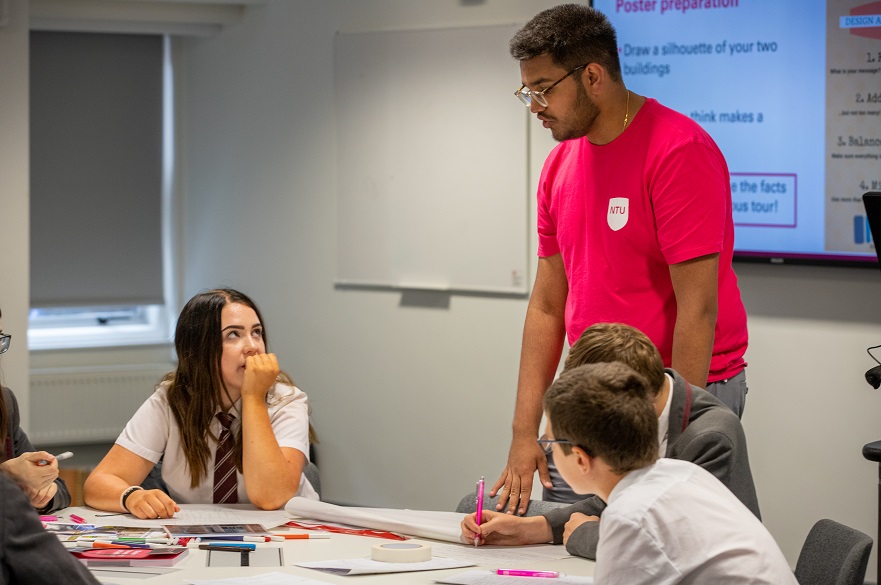 Outreach Ambassador on a campus visit working with a group of young people