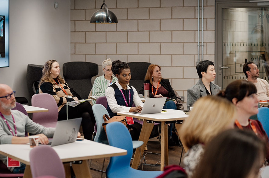 People sitting in a room with computers