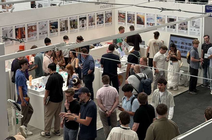 A busy exhibition with people viewing items on display.