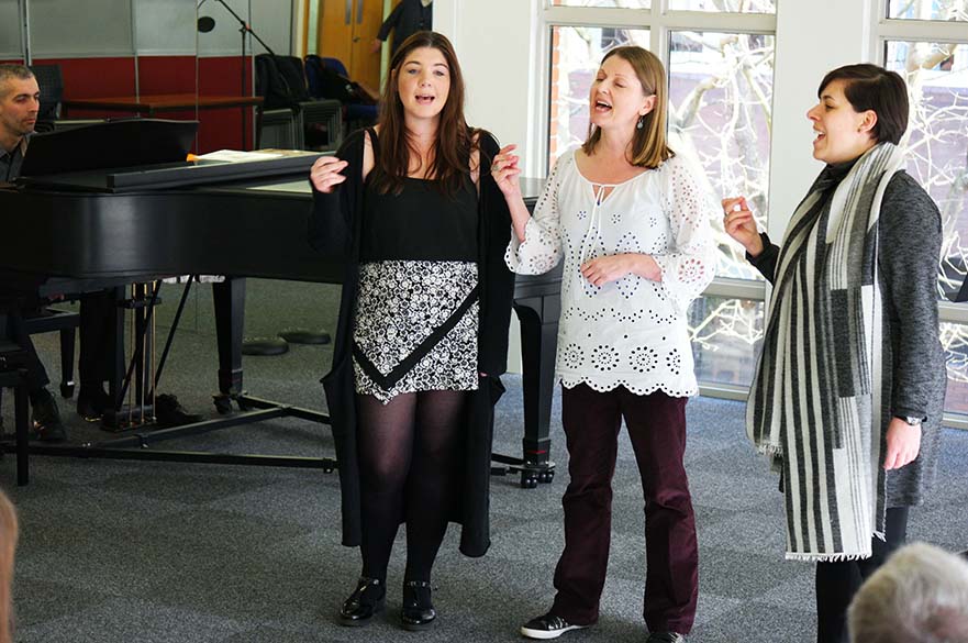 Students and staff singing in the music centre