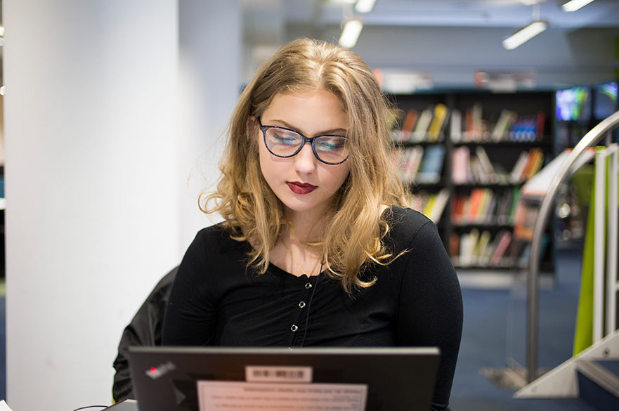 Student using laptop in NTU library