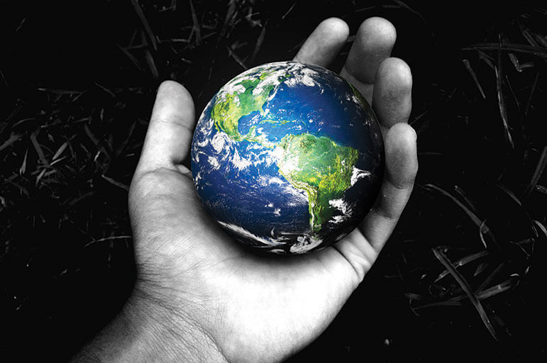 Hand holding planet Earth