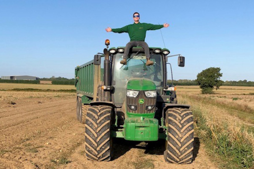 Student riding tractor