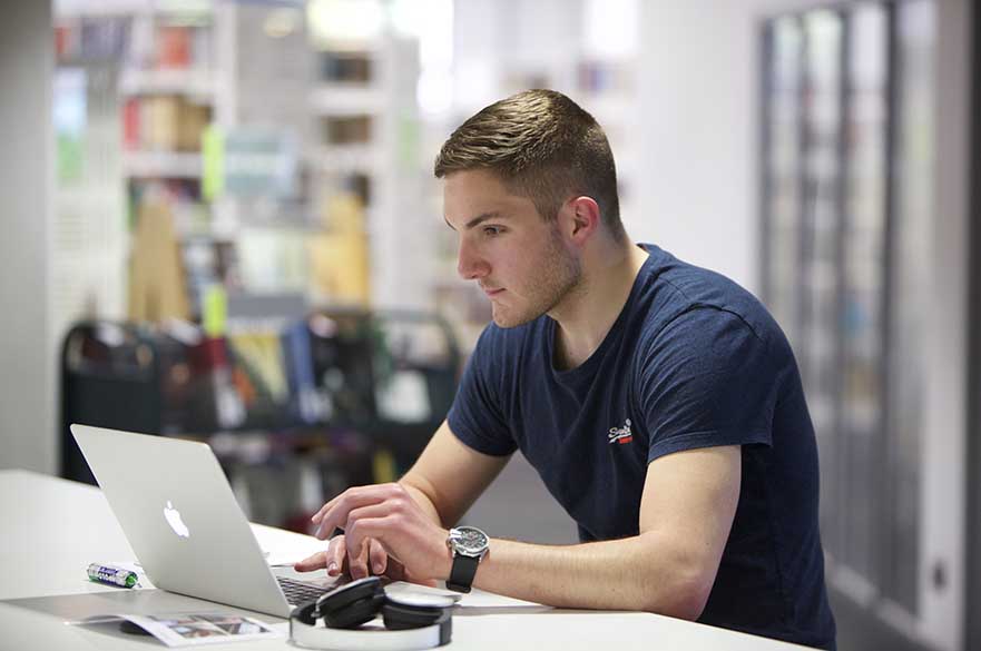 Student on laptop in Clifton Library