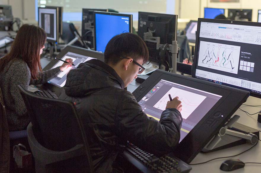 Male student working on a touch drawing screen.