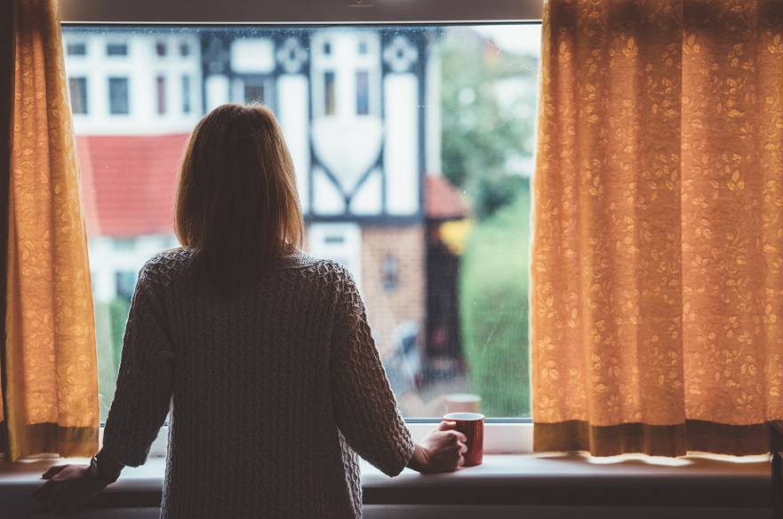 woman looking out of window