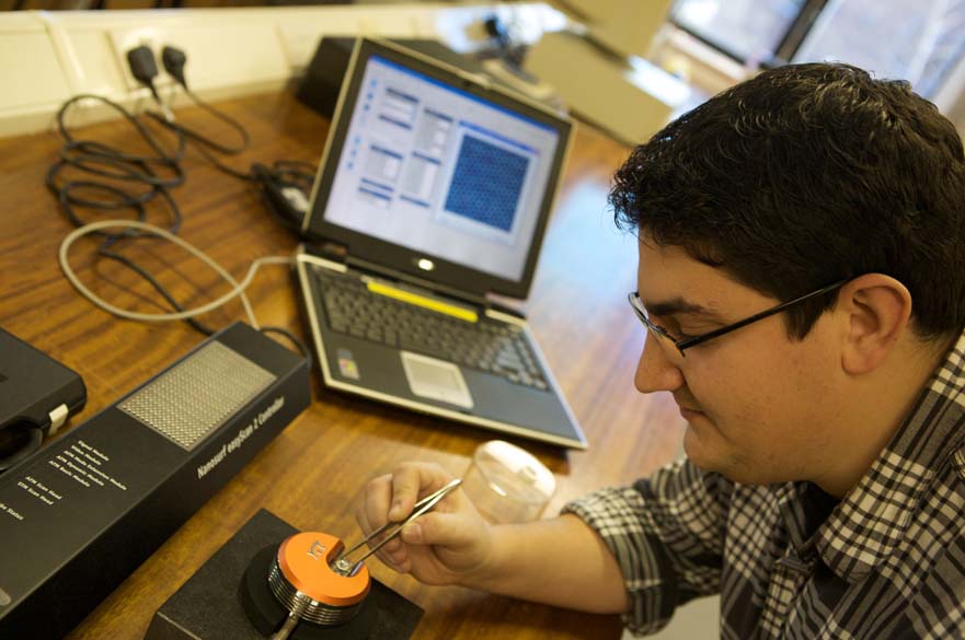 Student testing electrical equipment with laptop