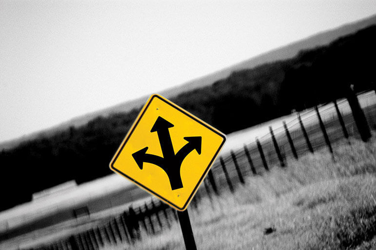 Yellow road sign with arrows