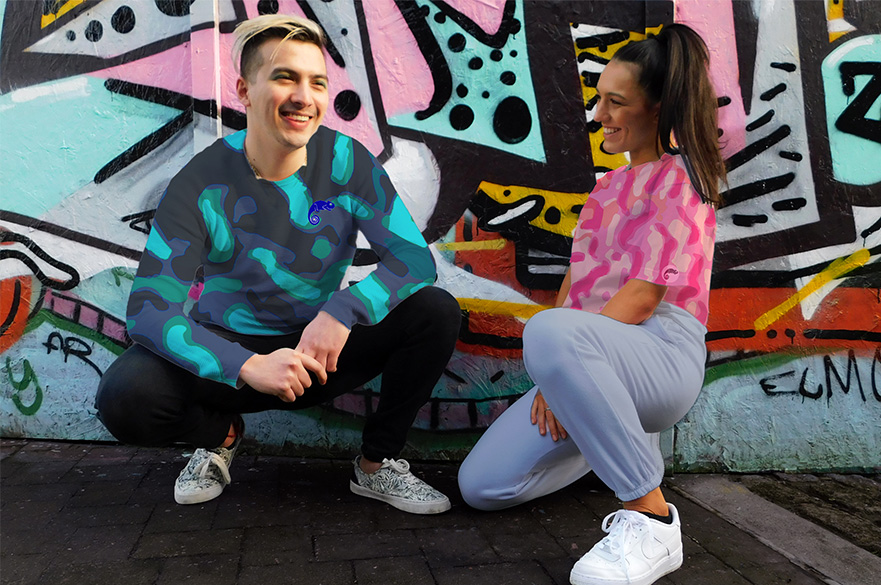 A man and woman crouched down wearing activewear and t-shirts designed by Textile Design students