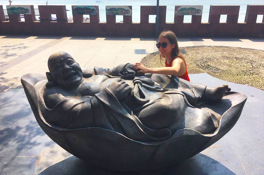 Patrycja with a buddha statue in China