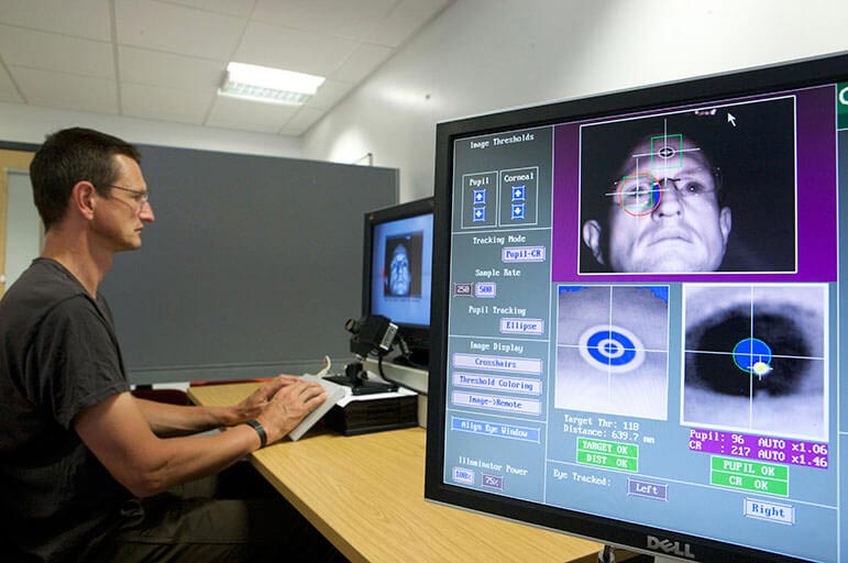 Person using pc with eye tracker technology