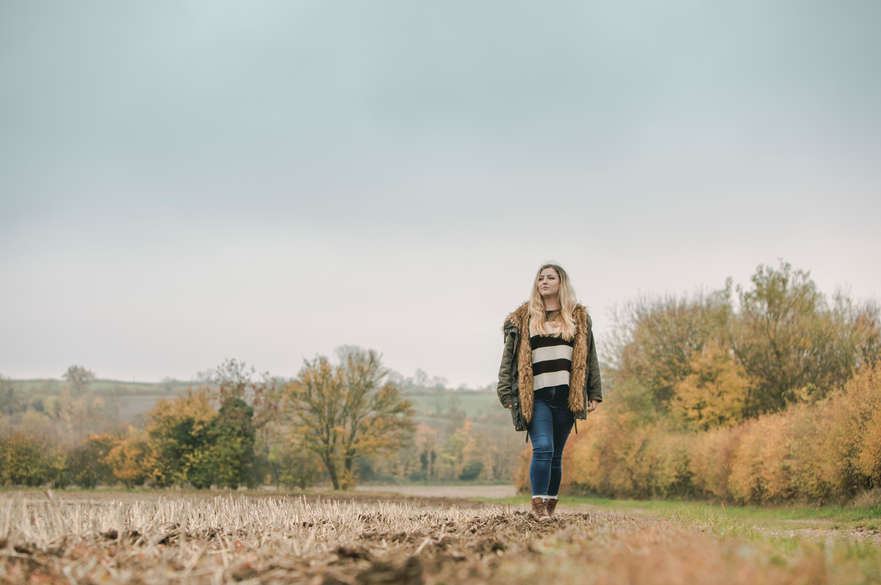 Student walking in a field