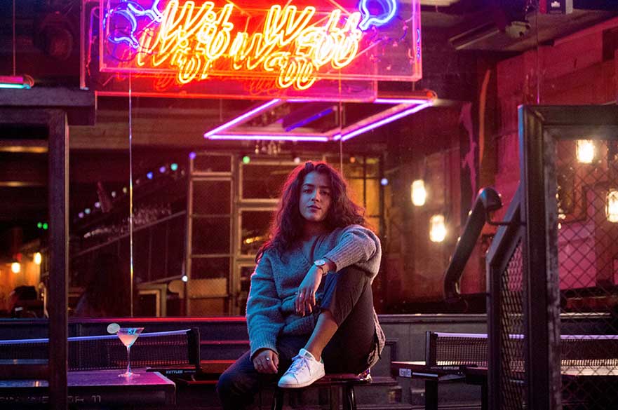 Arooj Aftab sat on a bench