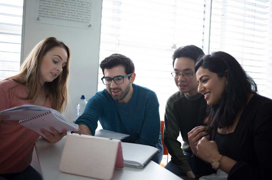 students sitting around a computer