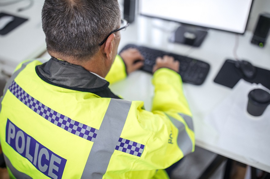 Police officer at computer