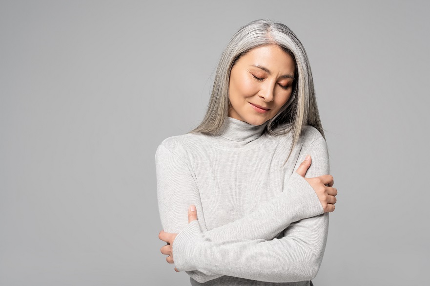 Woman hugging herself