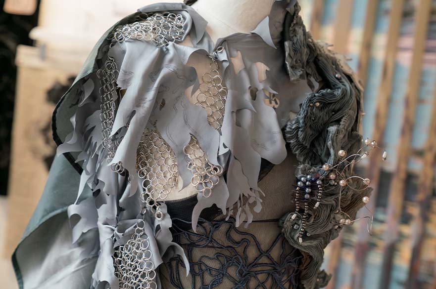 Close up shot of a black and grey mixed textile dress 