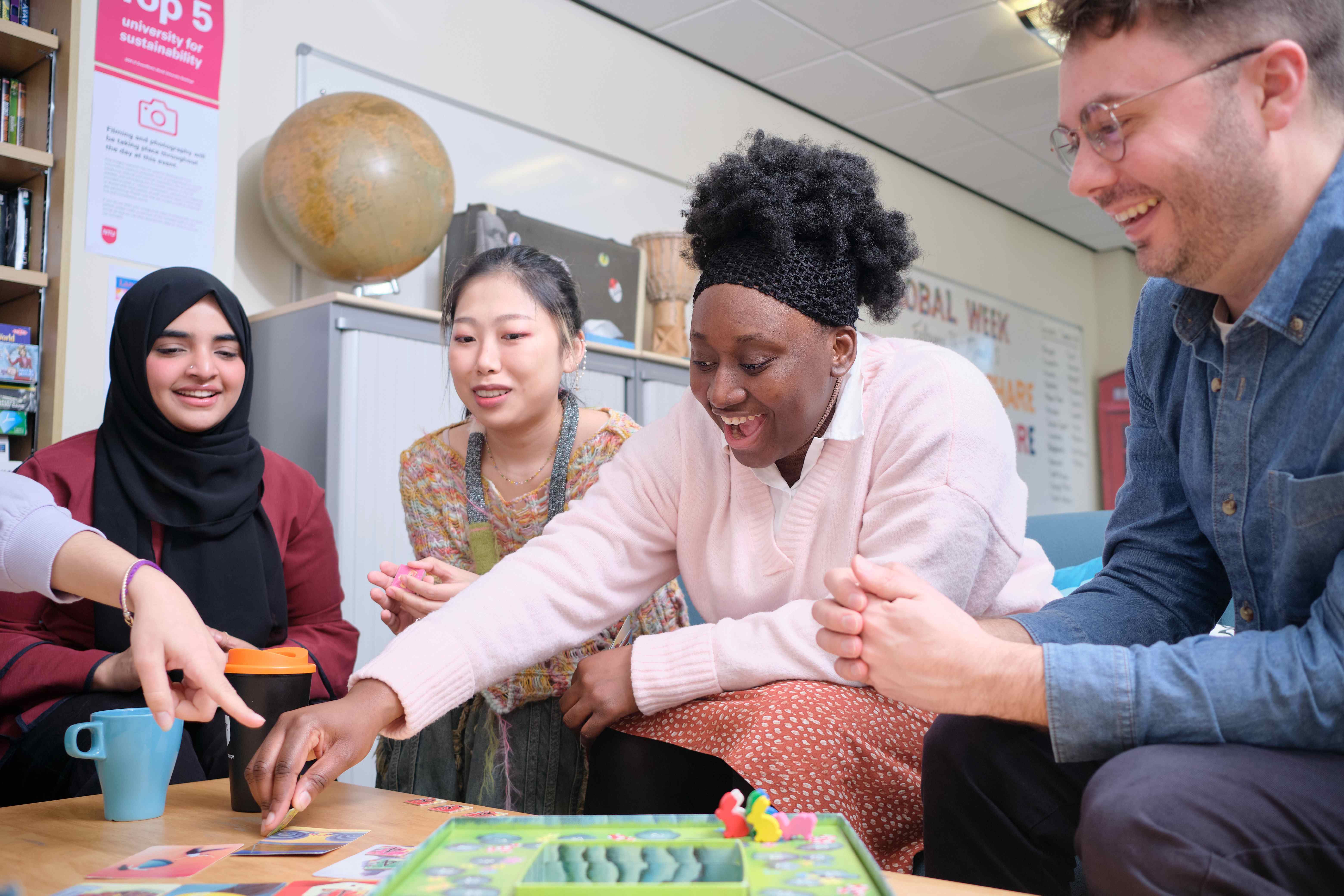 a group of international student playing board games at clifton global lounge