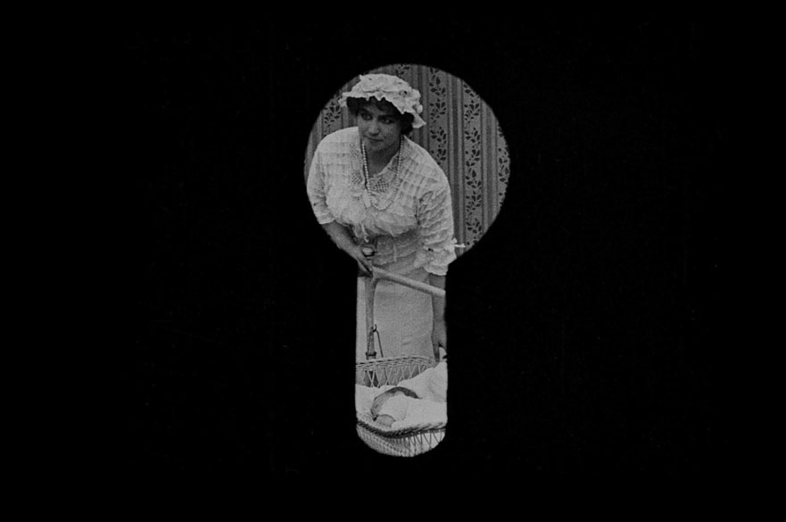 A black keyhole, looking at a woman.