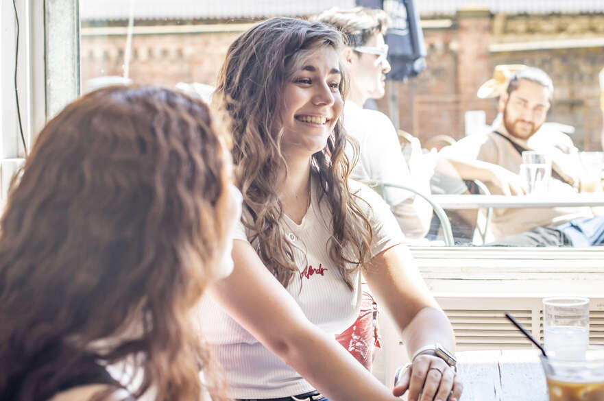 Two friends chatting in a cafe