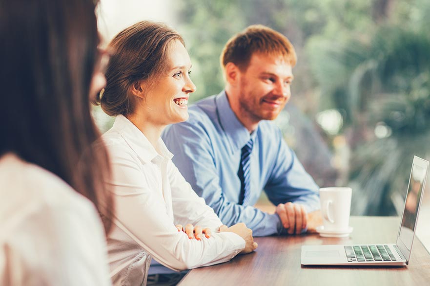 Smiling office workers in a meeting
