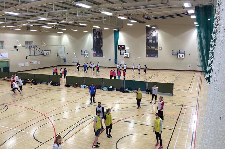 Students in sports hall taking part in FA session