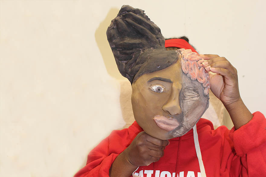 Female student holding a mask
