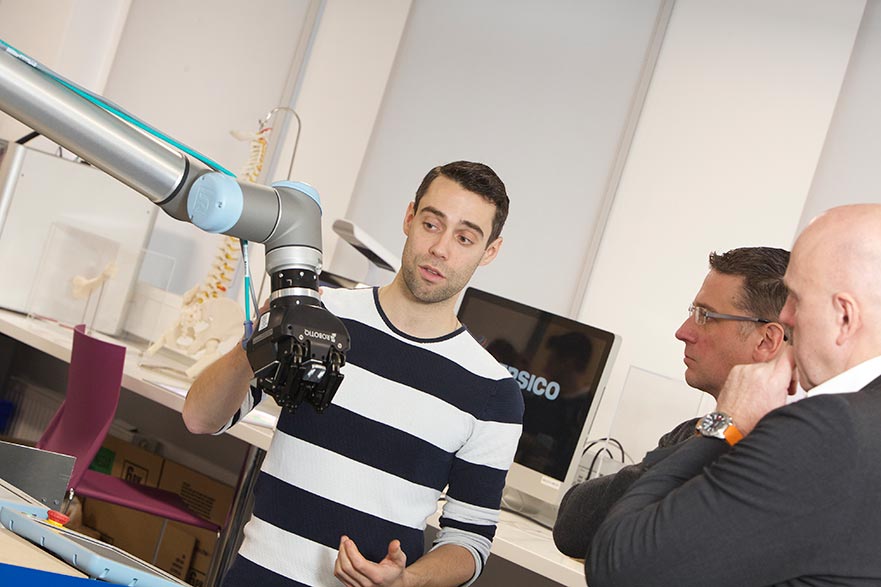 Pepsico's Steven Brooks (left) presents Professor Philip Breedon with the robotic arm