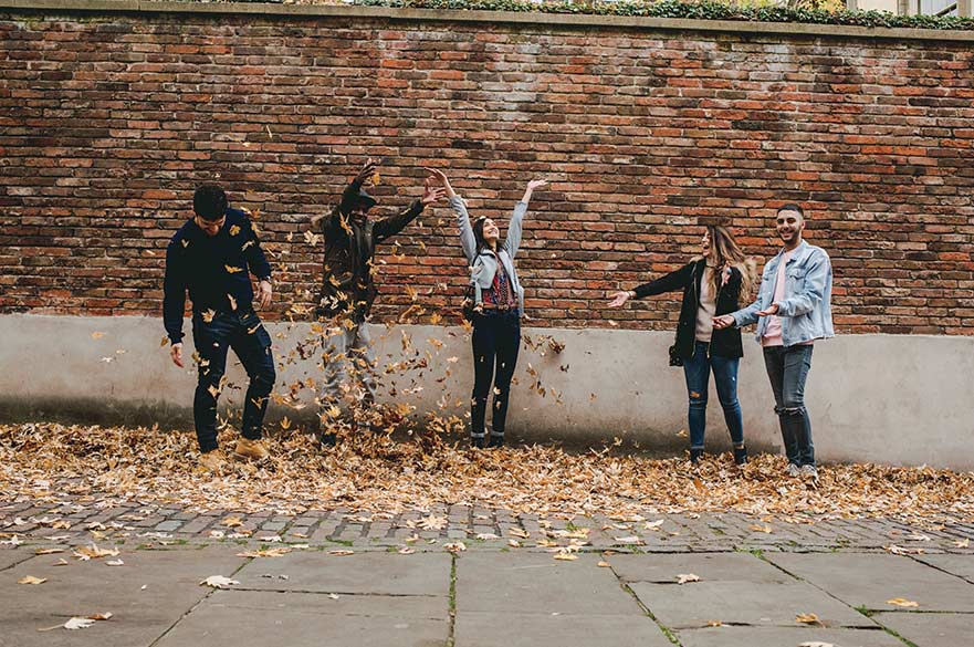 Students in Autumn leaves