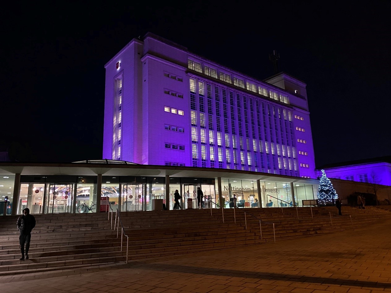 Newton building lit up in Purple