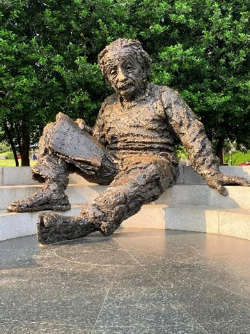 statue of a Albert Einstein sat on stairs