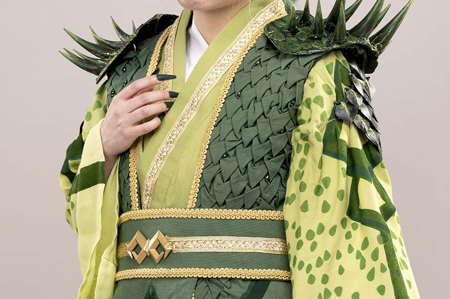Person wearing a green dragon themed costume