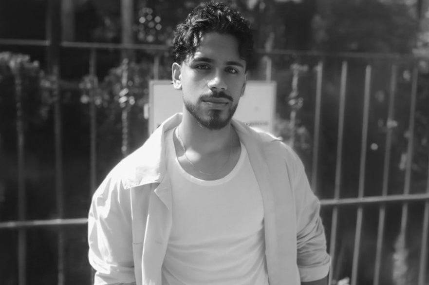 A person posing for a photograph.