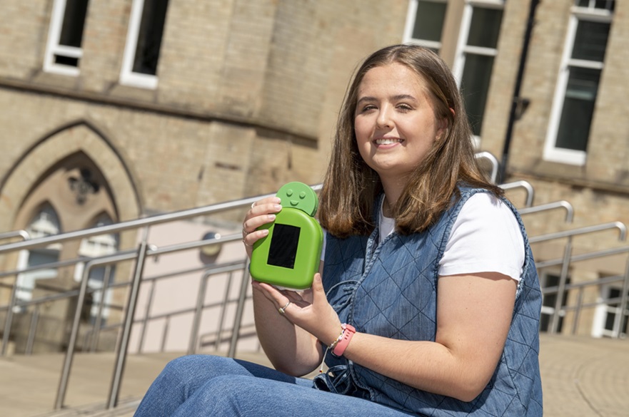 Ella Wood holding her prototype