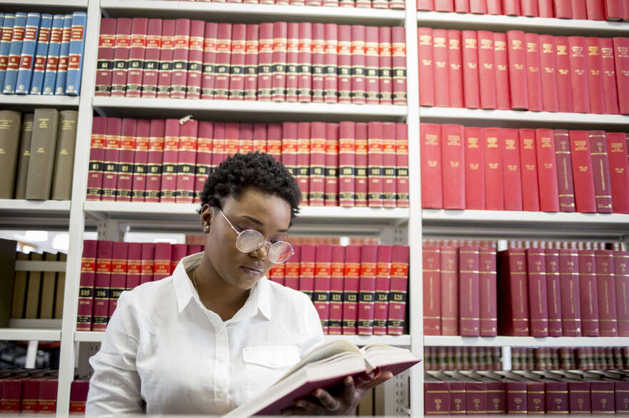 Student reading a book in the library