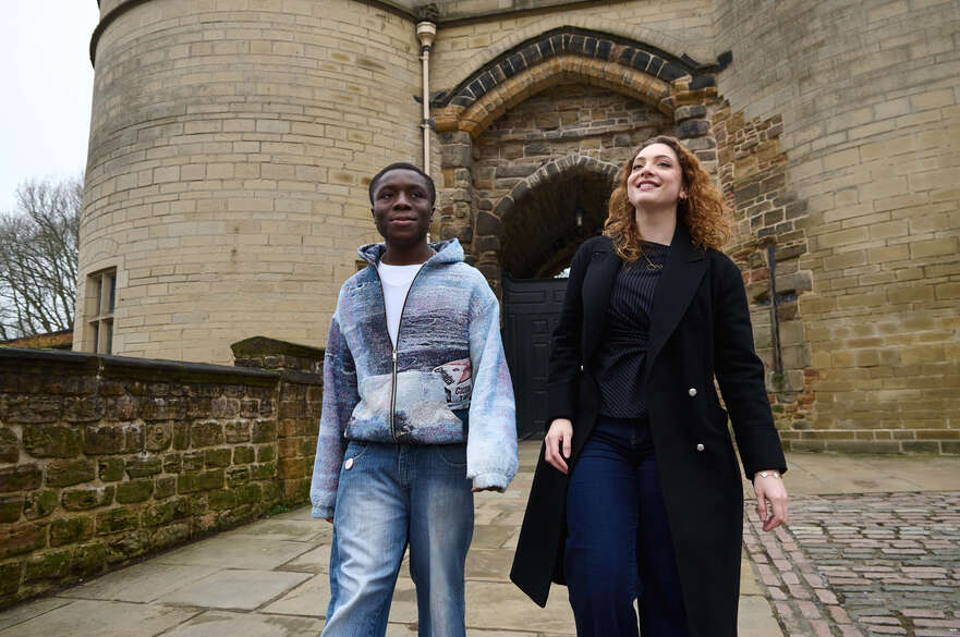 Two students walking out of the Nottingham Castle gate