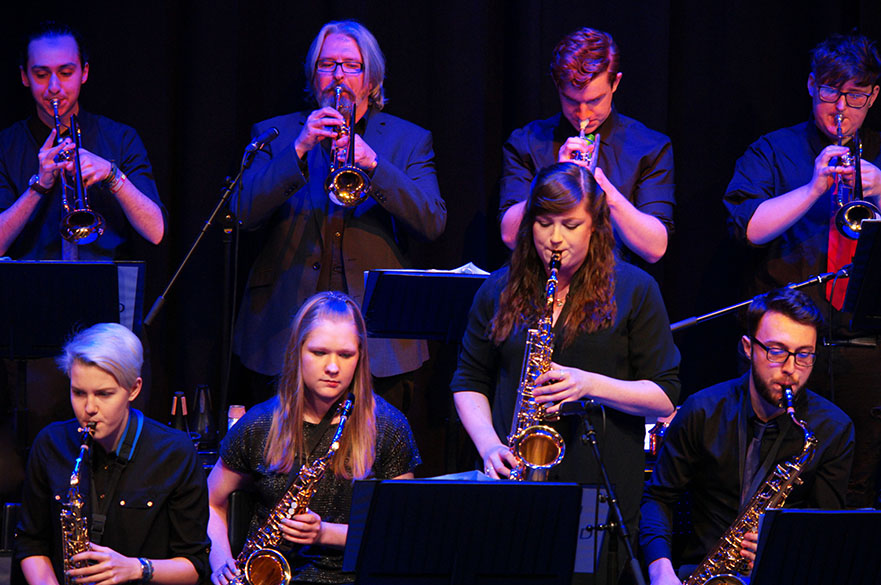 Students playing instruments on stage
