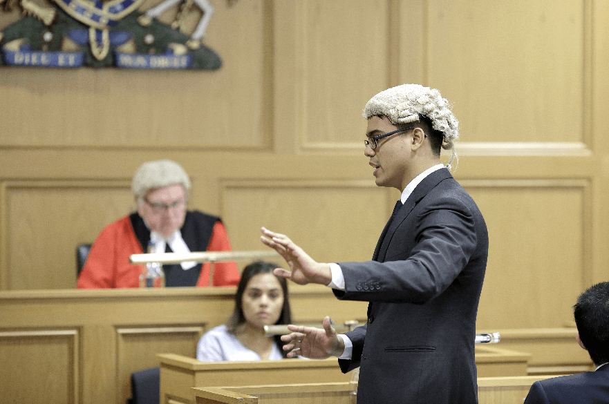 Student practising law in the courtroom at Nottingham Law School.