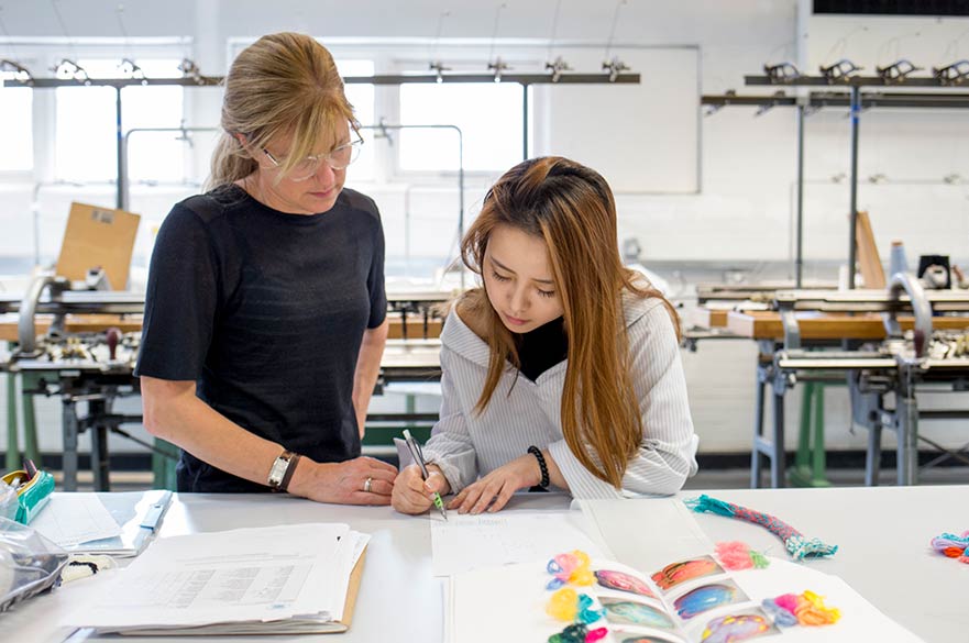 Student with lecturer in workshop