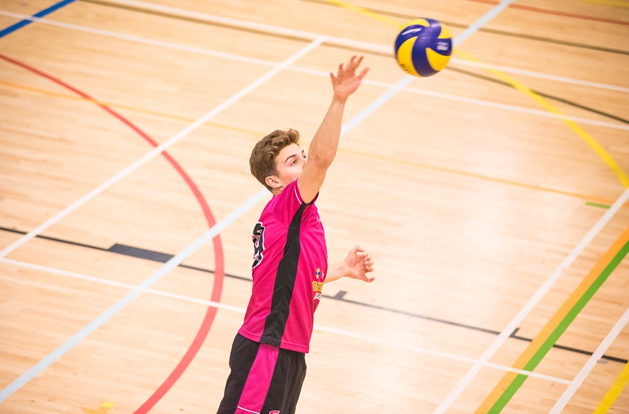 male Volleyball player hitting ball